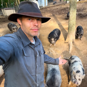 Aaron Riddle with pigs