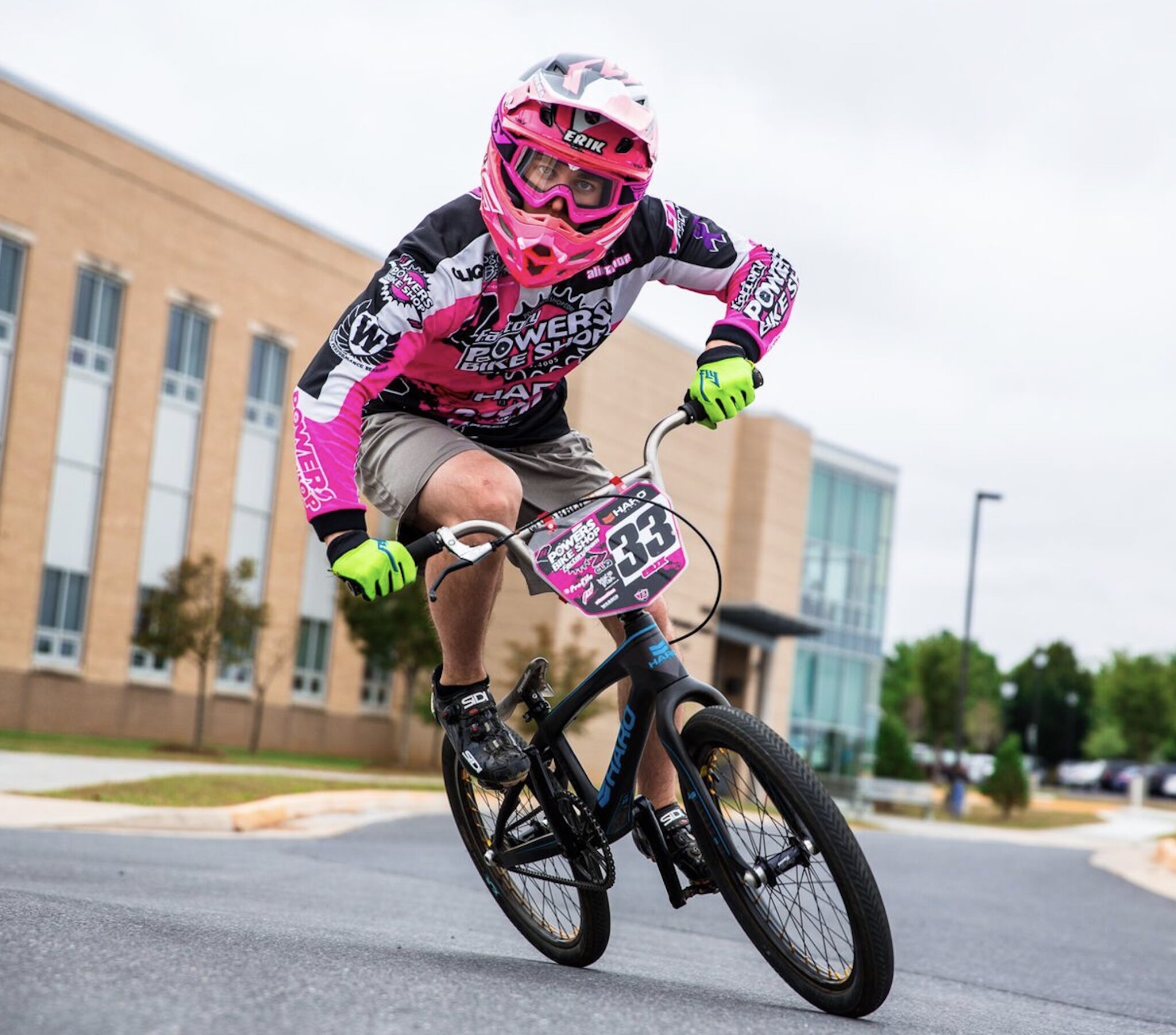 a photograph of student erik klein riding on his bmx bike wearing a helmet