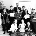 Black and white photo of students with awards