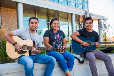 Group of students sitting on a wall