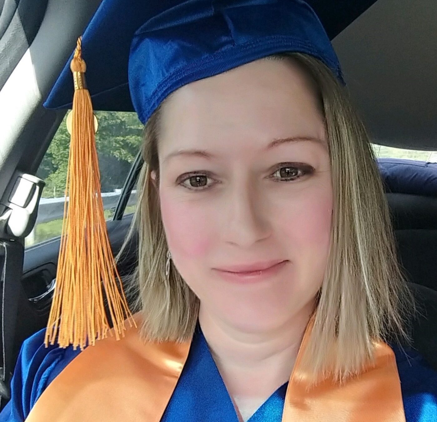 Julia Wickersham wearing a graduation cap and gown.