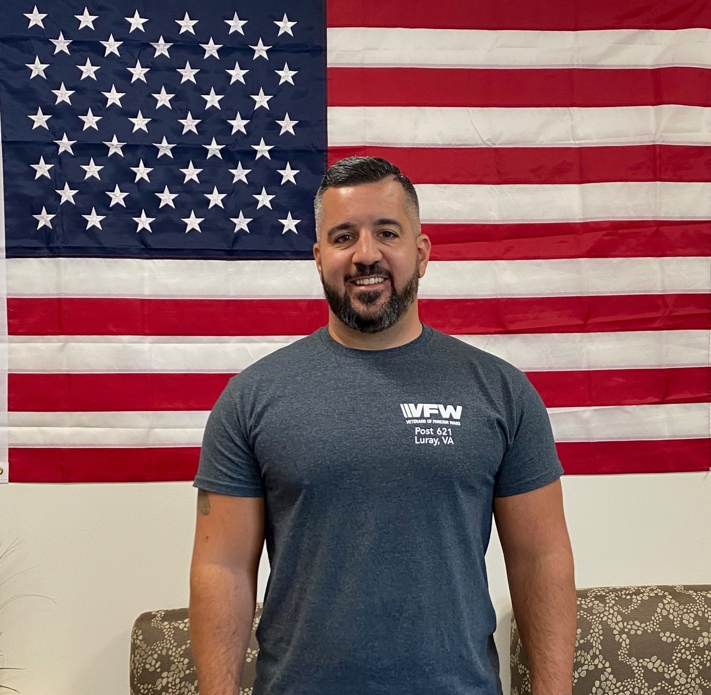 Photo of Brandon Tester in front of USA flag.