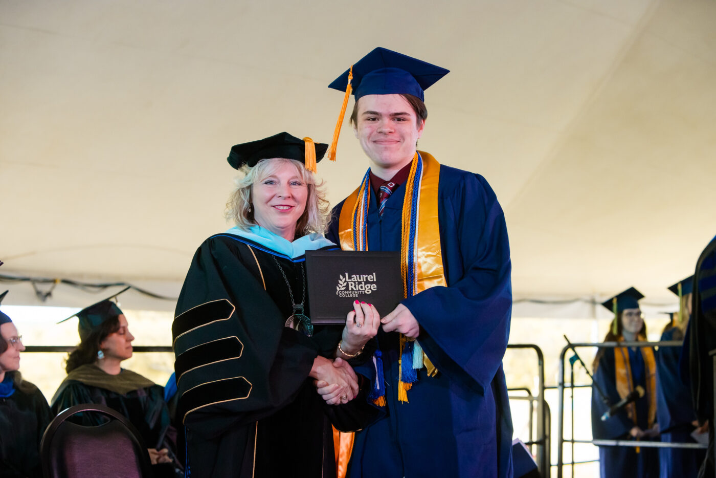 Weber receiving diploma