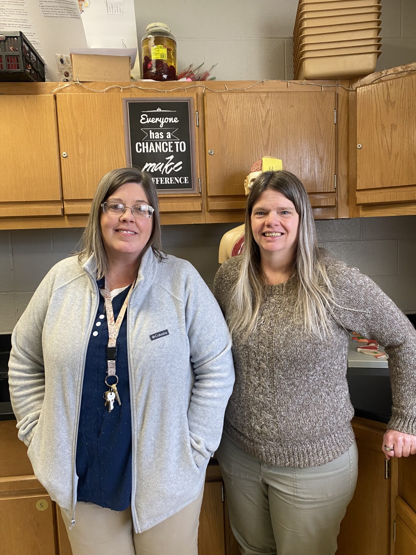 Image of ladies next to cabinets