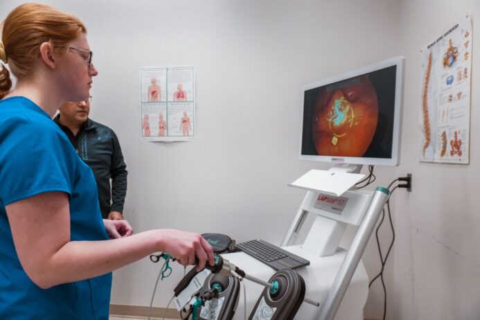 Photo of student using surgical simulator