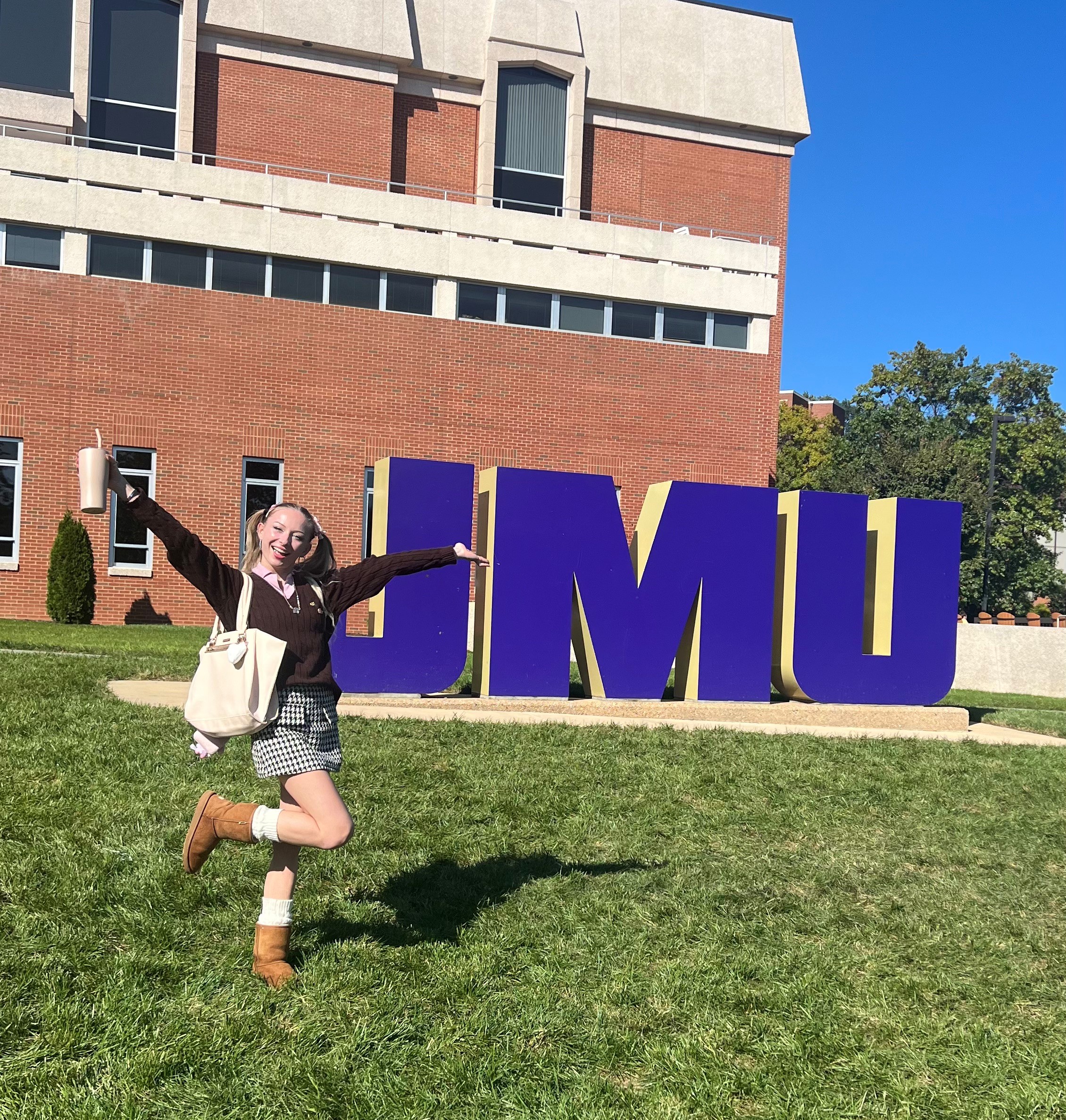 Hardy in front of JMU sign