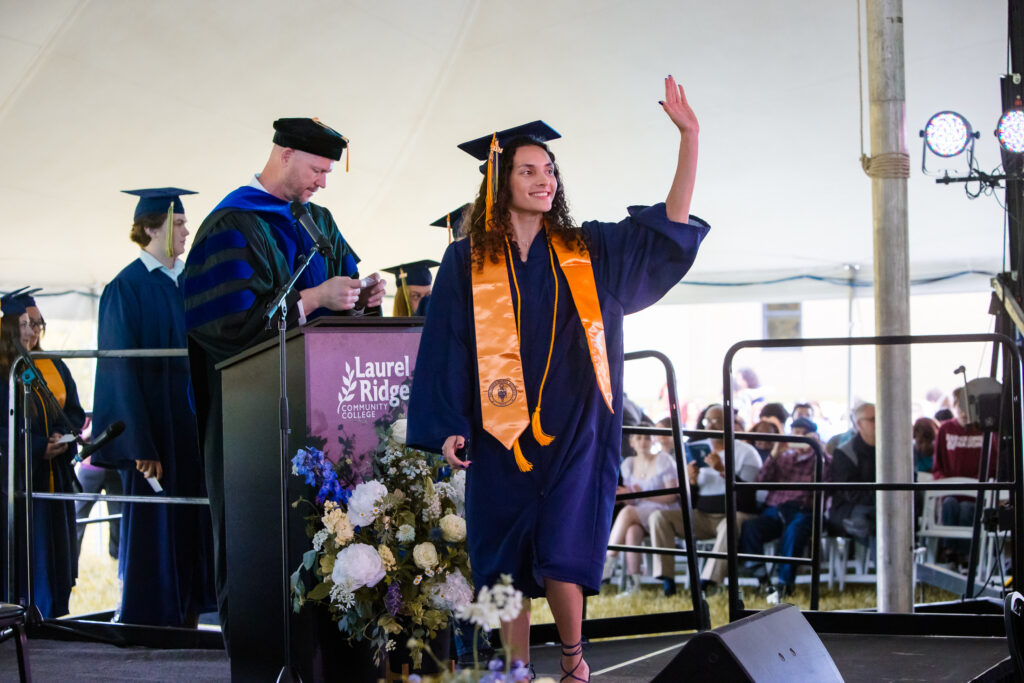photo of graduate walking across the stage