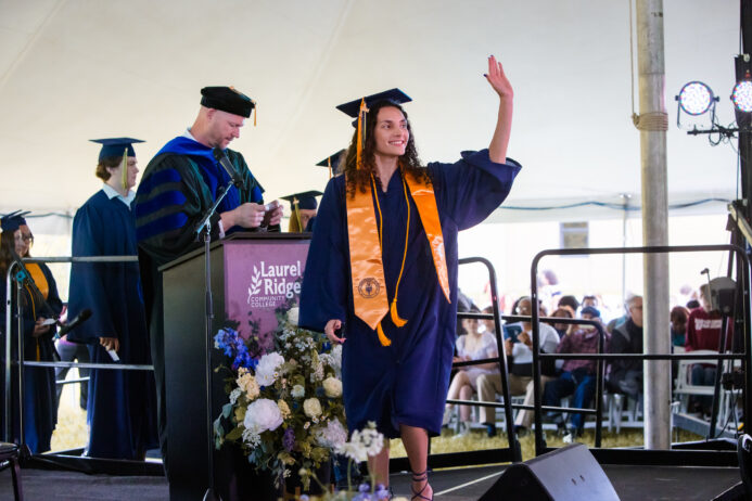 photo of graduate walking across the stage