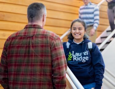 photograph of a smiling student wearing laurel ridge shirt