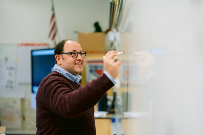 Photograph of a man named Jeff Keller writing on a white board