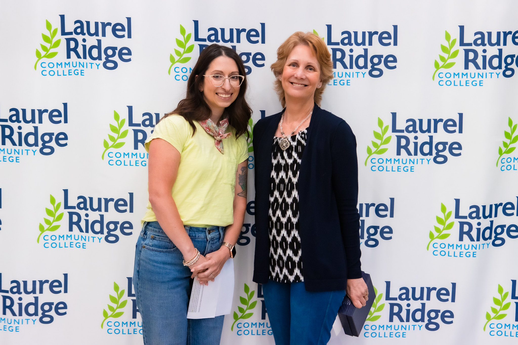 Two ladies standing together in front of Laurel Ridge backdrop