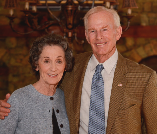 a photograph of an older woman and man looking forward and smiling