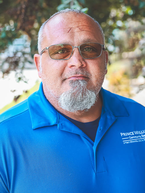 a headshot photograph of Will Fairhurst standing outside facing the camera