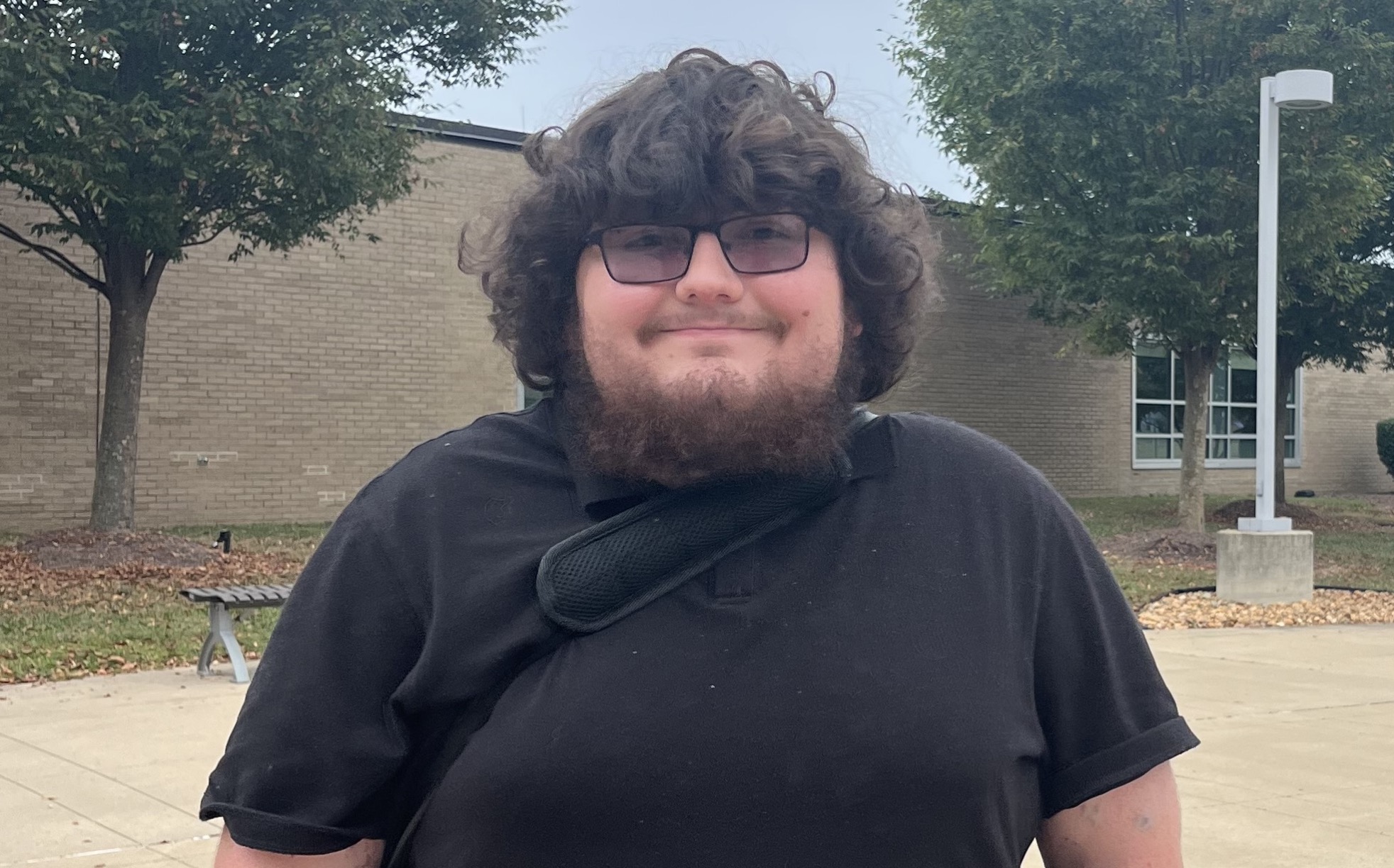 Photograph of a young man facing forward and smiling