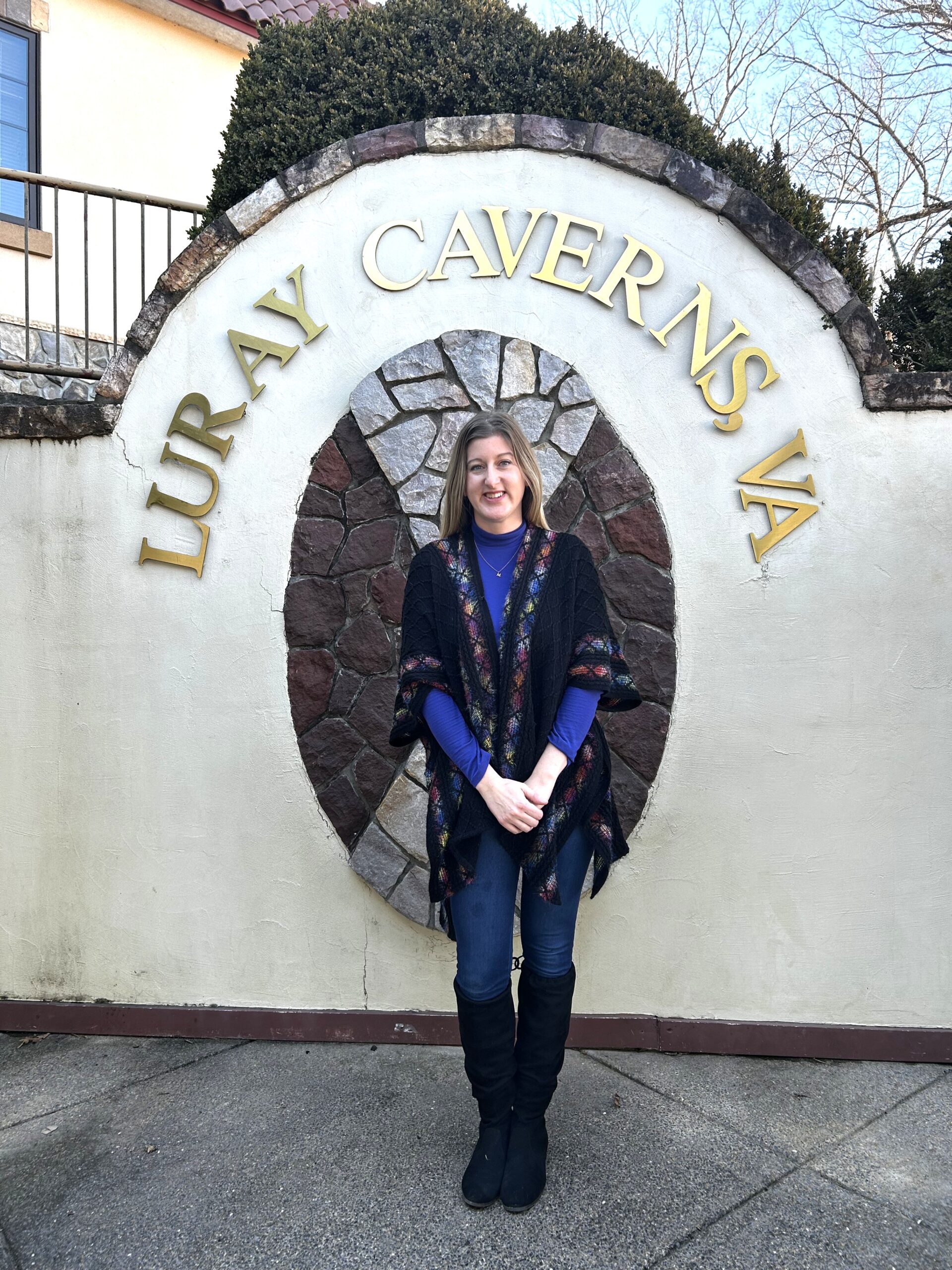 photograph of Katie standing in front of an archway with the words "Luray Caverns, VA"