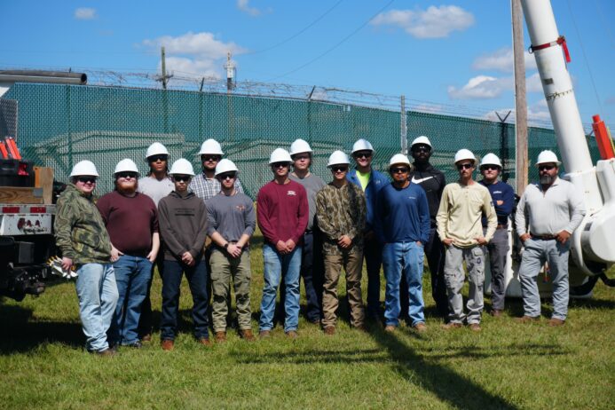 a group of power line graduates stand together