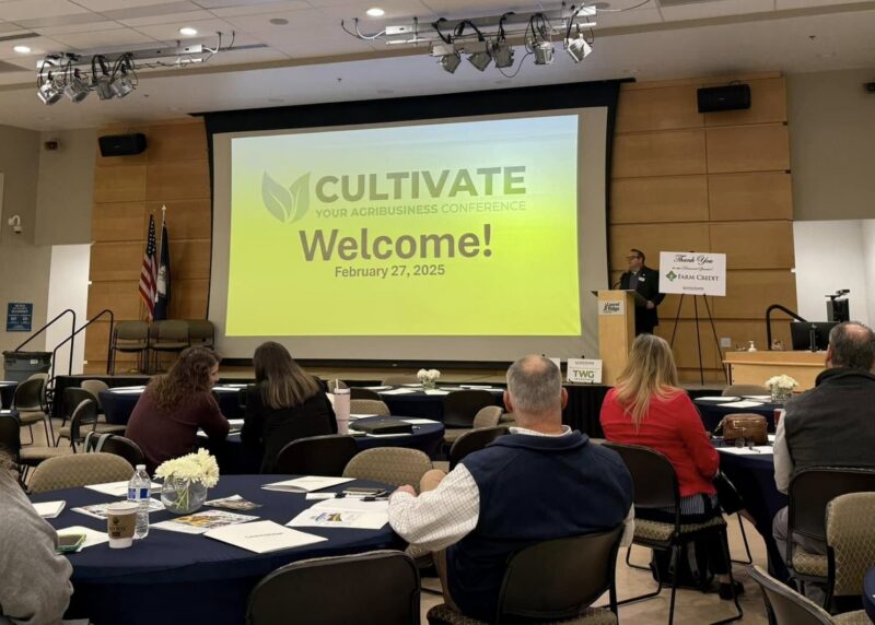 a photo of a conference with man at the podium speaking