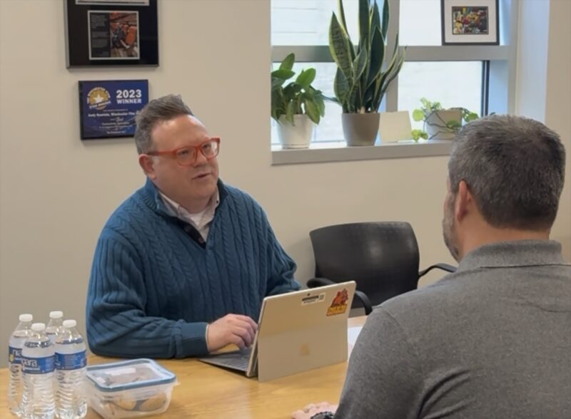 two men sit in talk in the office of the sbdc