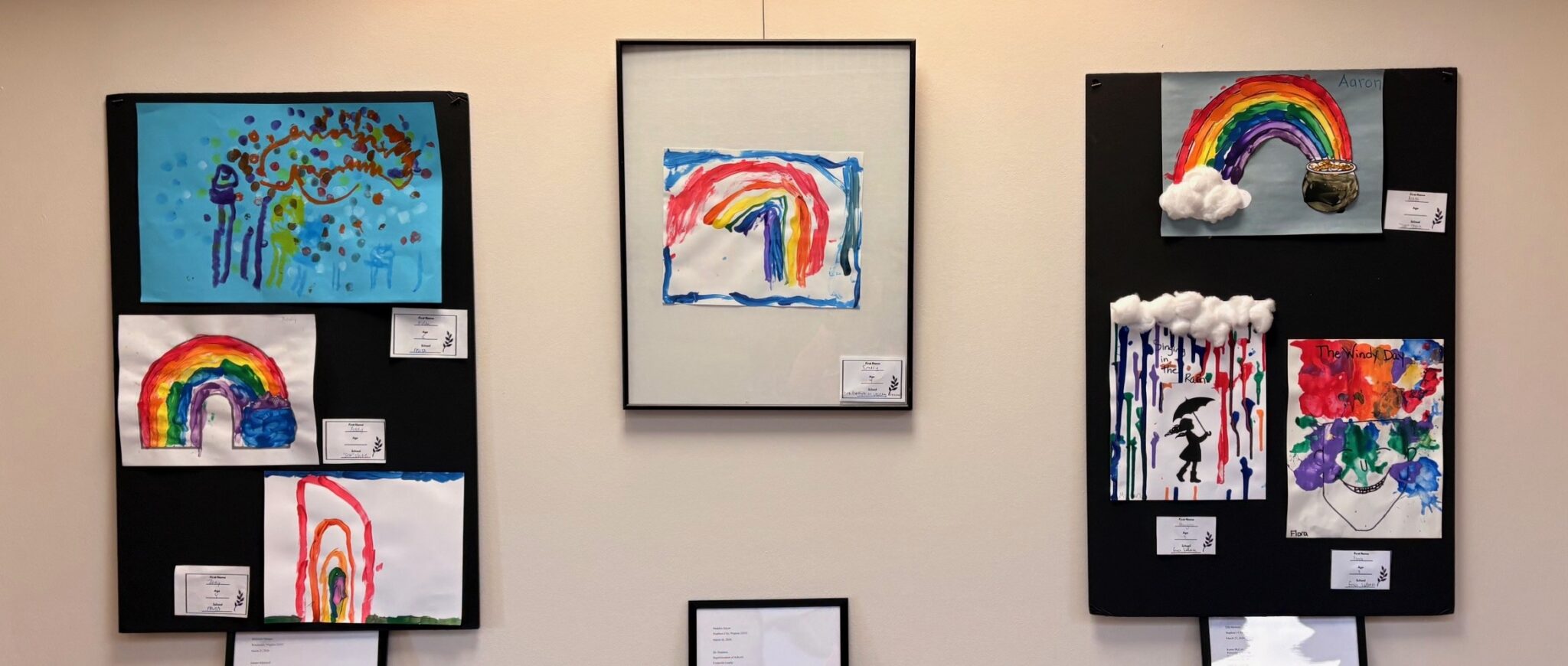 Artwork done by preschoolers hangs on the wall.