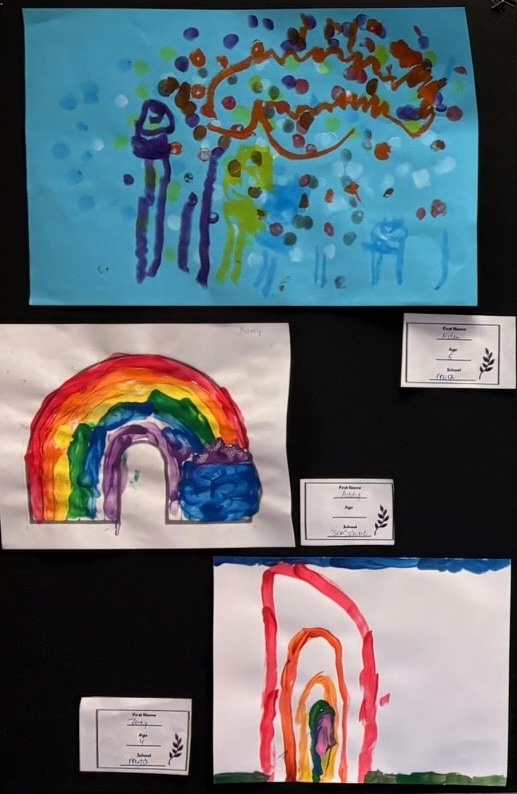 Artwork done by preschoolers hangs on the wall.