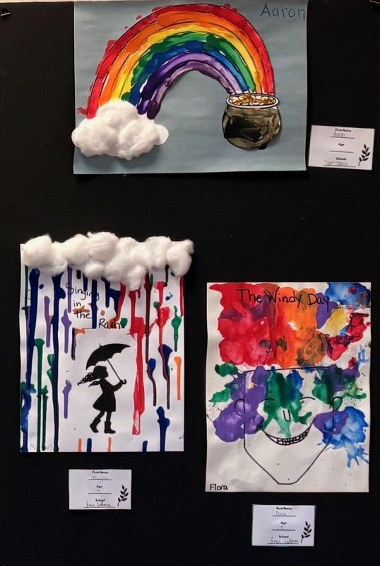 Artwork done by preschoolers hangs on the wall.