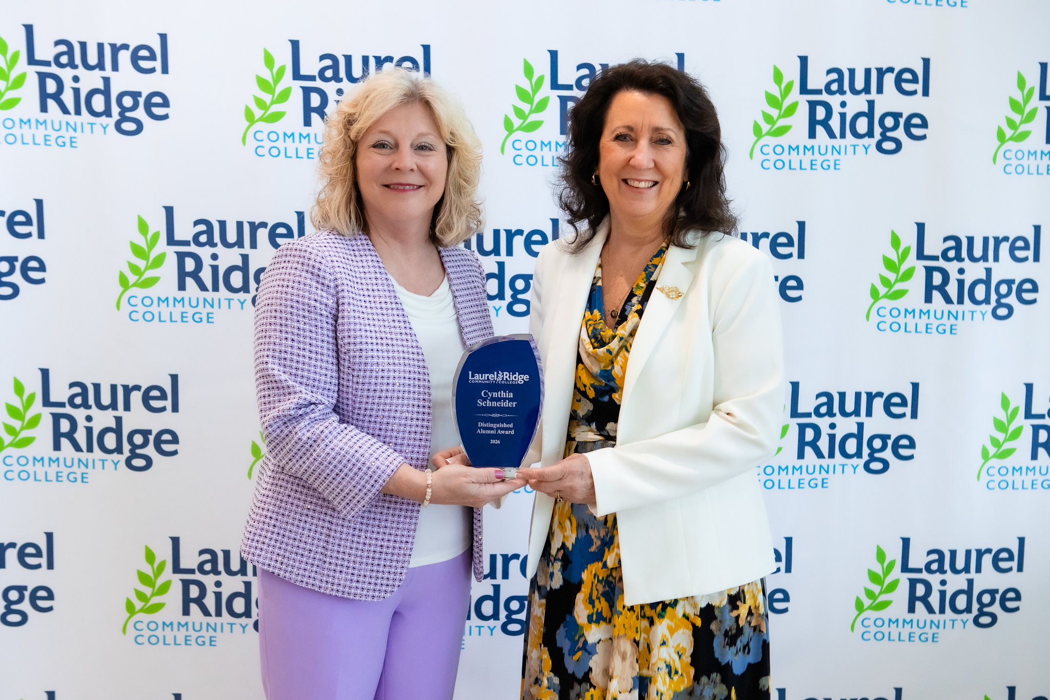 President Kim Blosser stands with alumni award winner Cynthia Schneider
