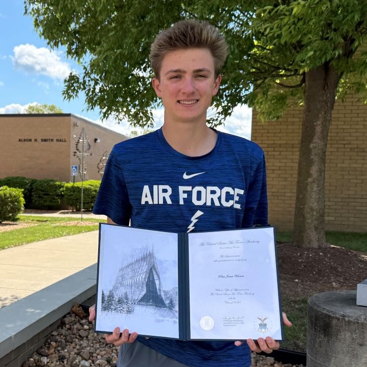 Peter Warner holding his appointment document to the air force academy.
