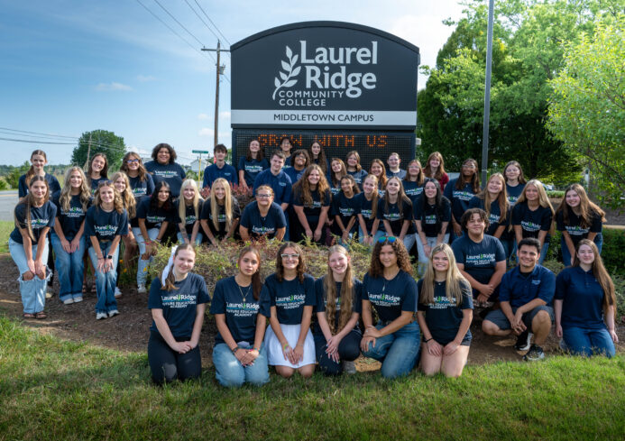 Group of Future Educators Academy students gathered outdoors in front of the Laurel Ridge Community College Middletown Campus sign, posing for a group photo on a sunny day.