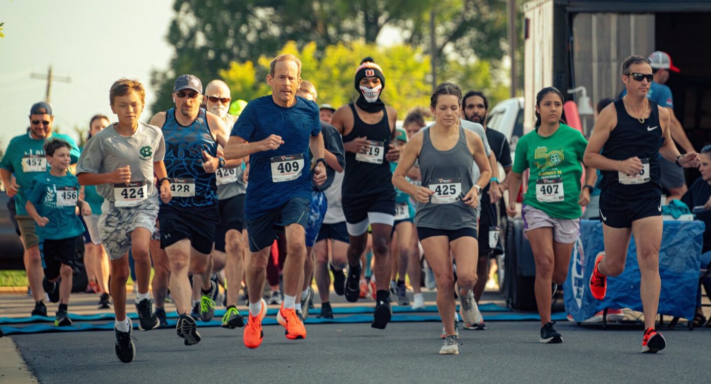 a group of people running at the start of a 5k race at Laurel Ridge Community College